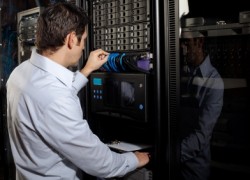 An IT technician works on a server network