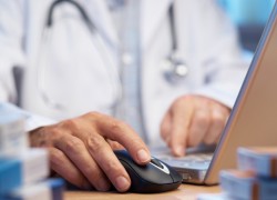 Doctor preparing online internet prescription